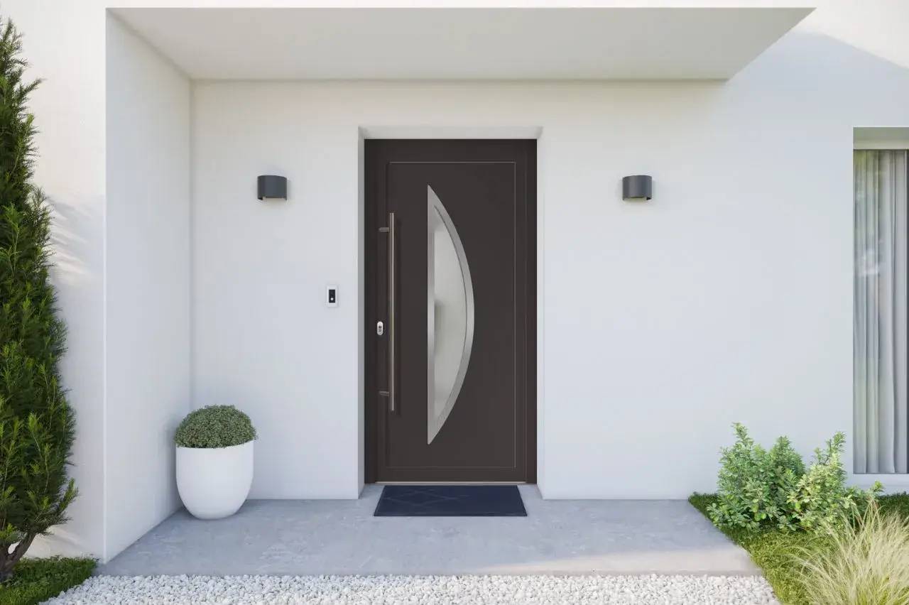Porte d'entrée moderne en bois foncé avec une décoration vitrée en arc, encadrée par un mur blanc minimaliste et flanquée